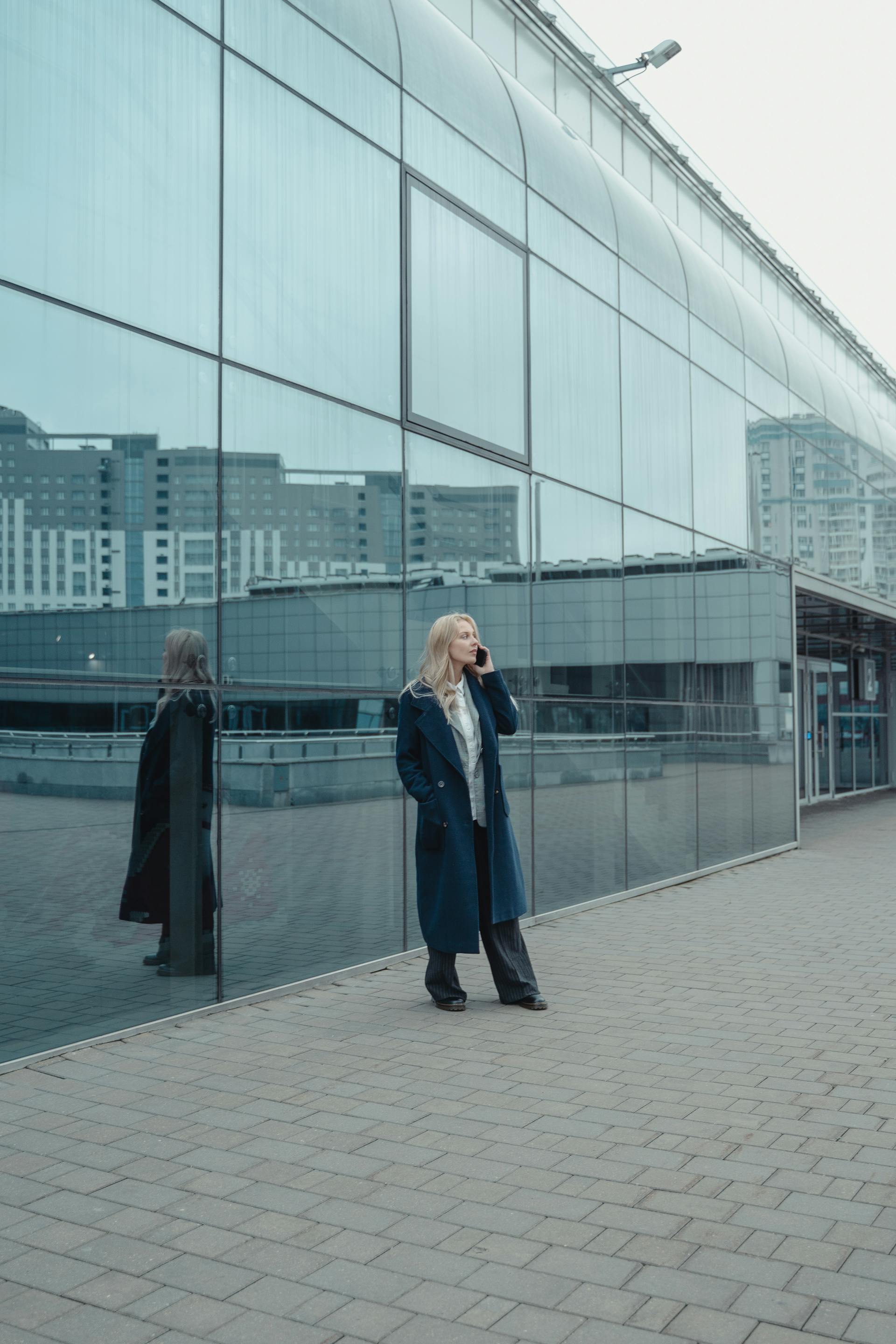 A woman talking on the phone outside a building | Source: Pexels