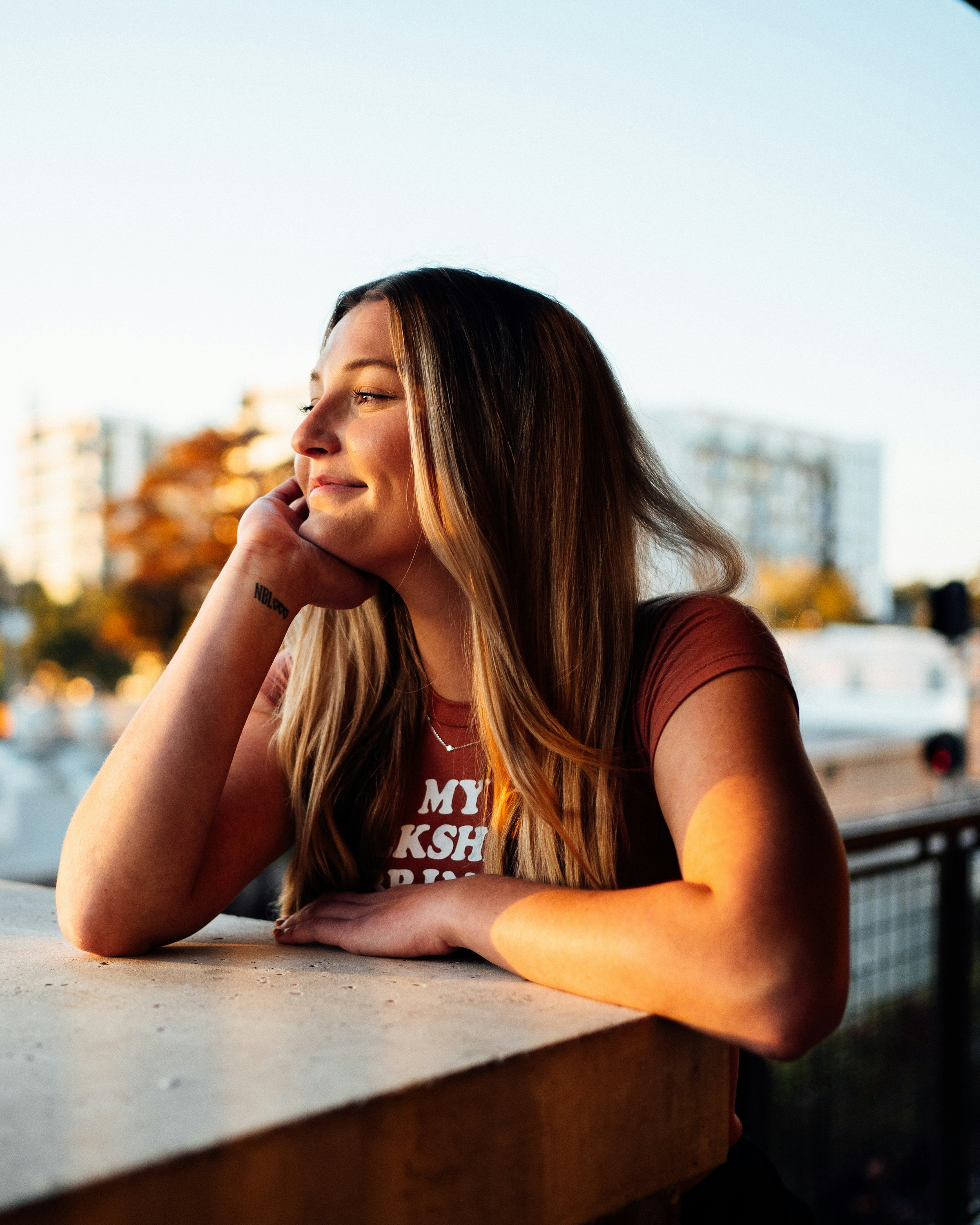 A smiling woman with a wrist tattoo | Source: Unsplash